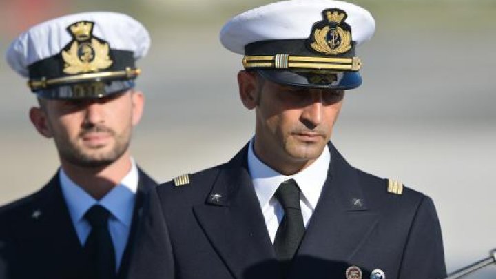 italian marines massimiliano lattore right and salvatore girone left arrive at ciampino airport near rome on december 22 2012 photo afp