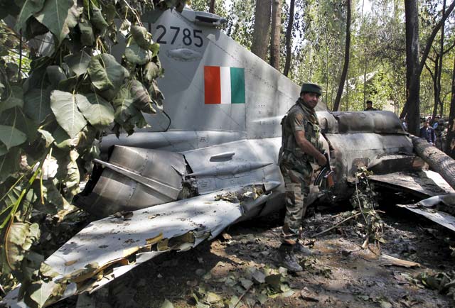 an indian army soldier stands in front of the wreckage of a mig 21 bison aircraft of the indian air force iaf after it crashed in soibugh in budgam district of kashmir august 24 2015 photo reuters