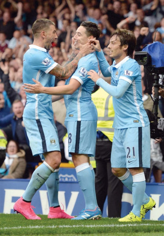 aleksandar kolarov and samir nasri earned manchester city a rare 2 0 success at everton on sunday that equalled a club record and sent them top of the premier league photo afp aleksandar kolarov and samir nasri earned manchester city a rare 2 0 success at everton on sunday that equalled a club record and sent them top of the premier league photo afp