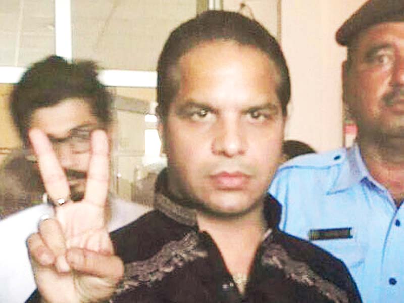 dj butt flashes a victory sign after being granted bail photo waseem nazir express