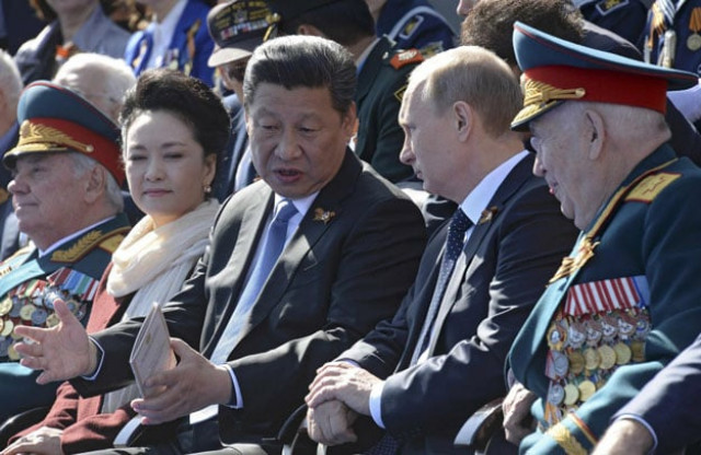 chinese president xi jinping speaks with russian president vladimir putin during the red square victory parade photo reuters