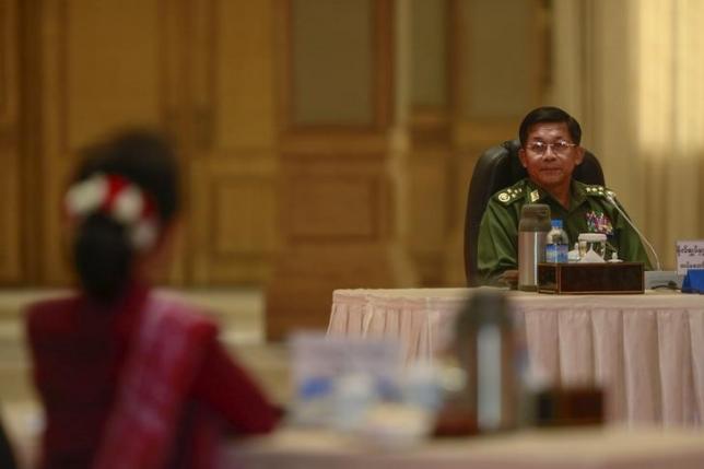 myanmar military commander in chief senior general min aung hlaing looks to myanmar pro democracy leader aung san suu kyi during myanmar 039 s top six party talks at the presidential palace at naypyitaw april 10 2015 photo reuters