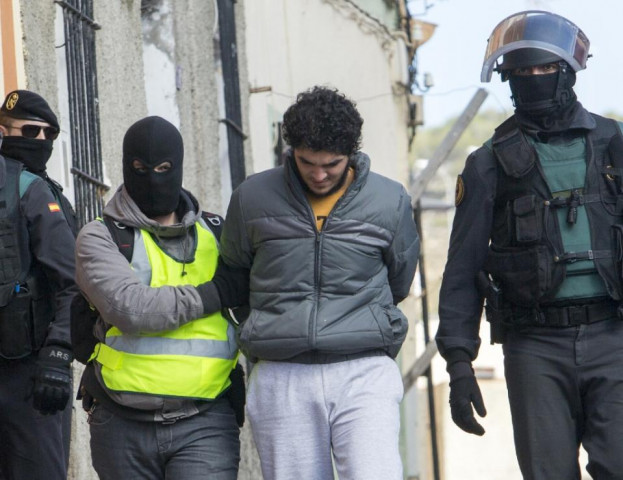 one of four people suspected of using internet platforms to recruit young women to join the islamic state group is arrested in the spanish enclave melilla on february 25 2015 photo afp one of four people suspected of using internet platforms to recruit young women to join the islamic state group is arrested in the spanish enclave melilla on february 25 2015 photo afp