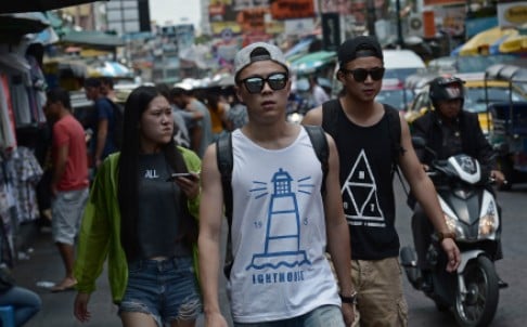 chinese tourists walk along khao san road popular with many foreign visitors in bangkok days after a bomb attack rocked the thai capital photo afp