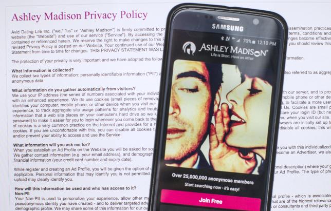 a photo illustration shows the privacy policy of the ashley madison website seen behind a smartphone running the ashley madison app in toronto august 20 2015 photo reuters