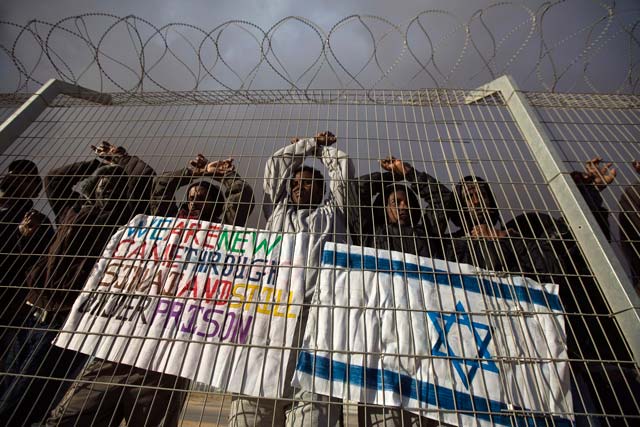 african migrants gesture behind a fence during a protest against israel 039 s detention policy towards them at holot israel 039 s southern negev desert detention centre february 17 2014 photo reuters