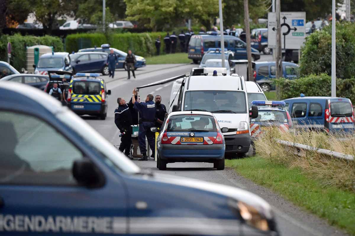 members of the gendarmes forensic unit set up a workspace on a road near a gypsy camp the site of a shooting photo afp