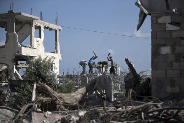 palestinian workers remove the rubble of a building that was destroyed during the 50 day war between israel and hamas militants in the summer of 2014 on august 25 2015 in gaza city 039 s eastern suburb of al shejaiya photo afp palestinian workers remove the rubble of a building that was destroyed during the 50 day war between israel and hamas militants in the summer of 2014 on august 25 2015 in gaza city 039 s eastern suburb of al shejaiya photo afp