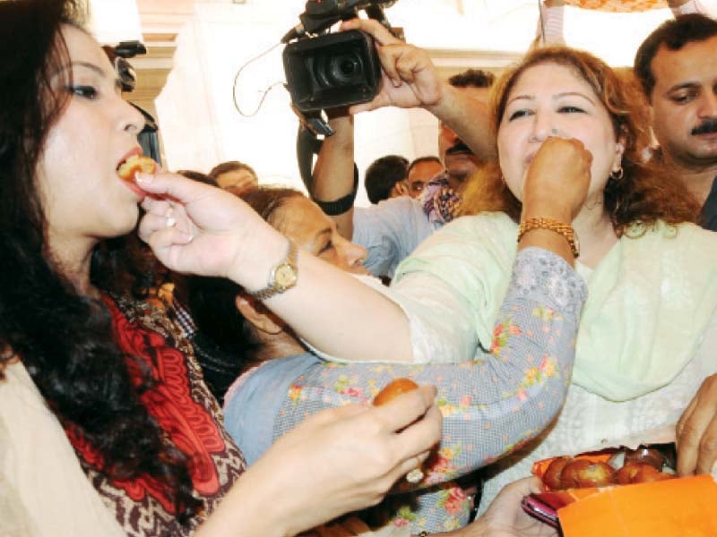 pti mpas offer sweets to their colleagues to celebrate election tribunal s verdict on na 154 photo riaz ahmed express