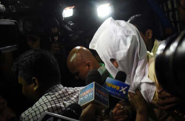 sanjeev khanna ex husband of sheena bora and suspect in her murder along with indrani mukerjea   the wife of former head of entertainment group star india peter mukerjea   is escorted out of a police station in kolkata on august 26 2015 photo afp