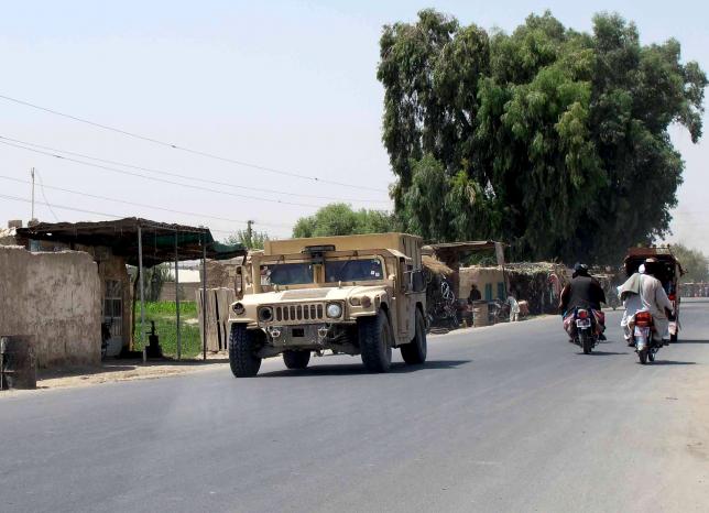 an afghan national police armored vehicle patrols on a street in lashkar gah capital of helmand province afghanistan august 26 2015 photo reuters