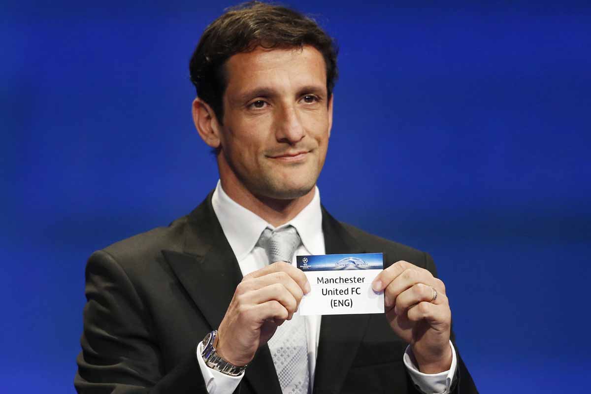 former argentinian defender javier zanetti holds up the draw for epl club manchester united during the champions league draw photo afp