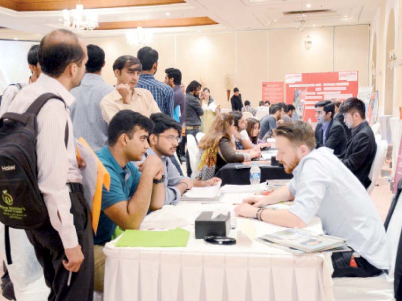 students at the expo listen intently to representatives from australian universities photo express