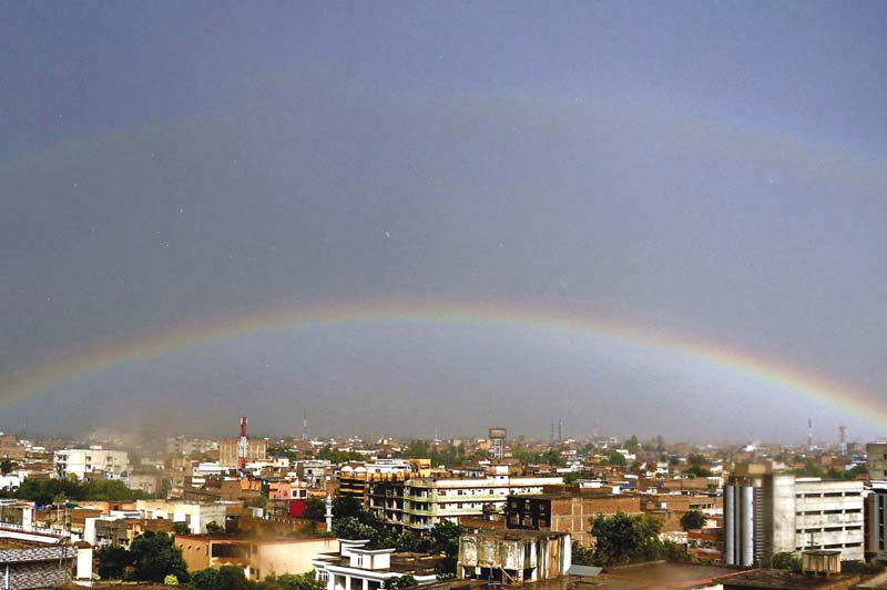 a rainbow appears after a heavy downpour in the city photo ppi