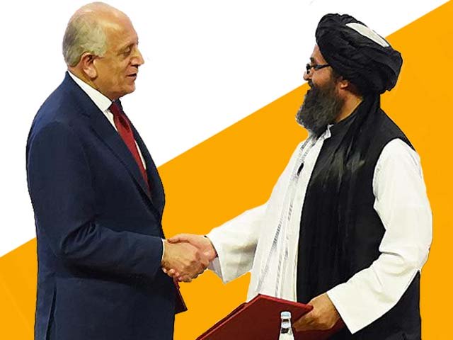 mullah abdul ghani baradar and zalmay khalilzad shake hands photo getty