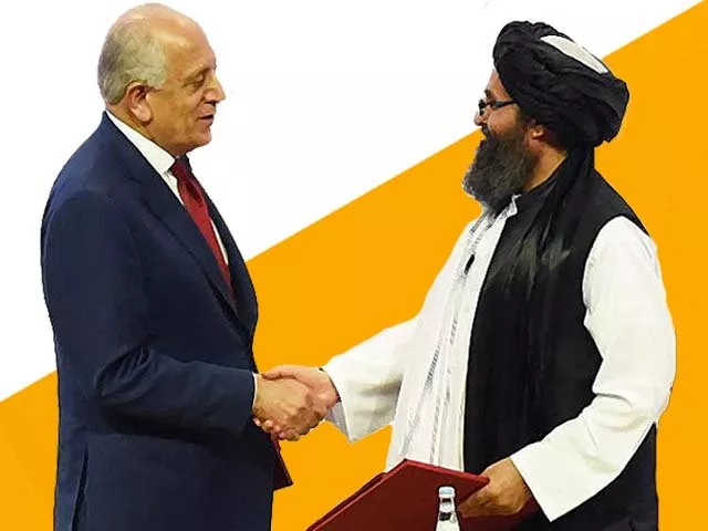 mullah abdul ghani baradar and zalmay khalilzad shake hands photo getty mullah abdul ghani baradar and zalmay khalilzad shake hands photo getty