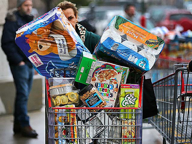 shoppers stock up on staples including toilet paper bottled water diapers and canned goods photo getty