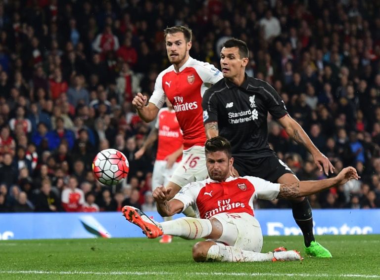 arsenal 039 s olivier giroud bottom has a shot at goal past liverpool 039 s dejan lovren during their english premier league match at the emirates stadium on august 24 2015 photo afp