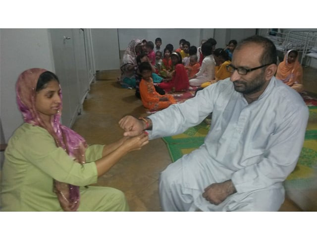 geeta ties a rakha on faisal edhi 039 s hand photo edhi foundation