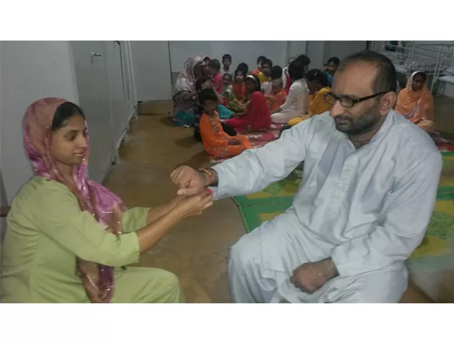 geeta ties a rakha on faisal edhi 039 s hand photo edhi foundation geeta ties a rakha on faisal edhi 039 s hand photo edhi foundation