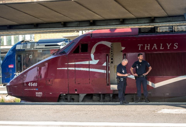 french police stand guard along the platform next to a thalys train at the main train station in arras northern france on august 22 2015 photo afp