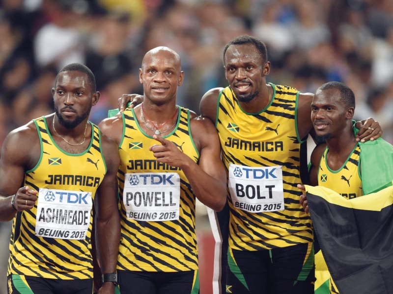 the jamaican relay team l r nesta carter asafa powell usain bolt and nickel ashmeade pose for photographers after winning the final of the men 039 s 4x100 metres relay athletics event at the 2015 iaaf world championships at the quot bird 039 s nest quot national stadium in beijing on august 29 2015 photo afp