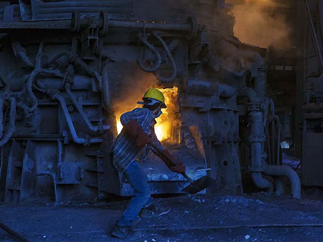 an employee shovels coal into a furnace used for smelting iron inside a steel plant in karachi photo getty