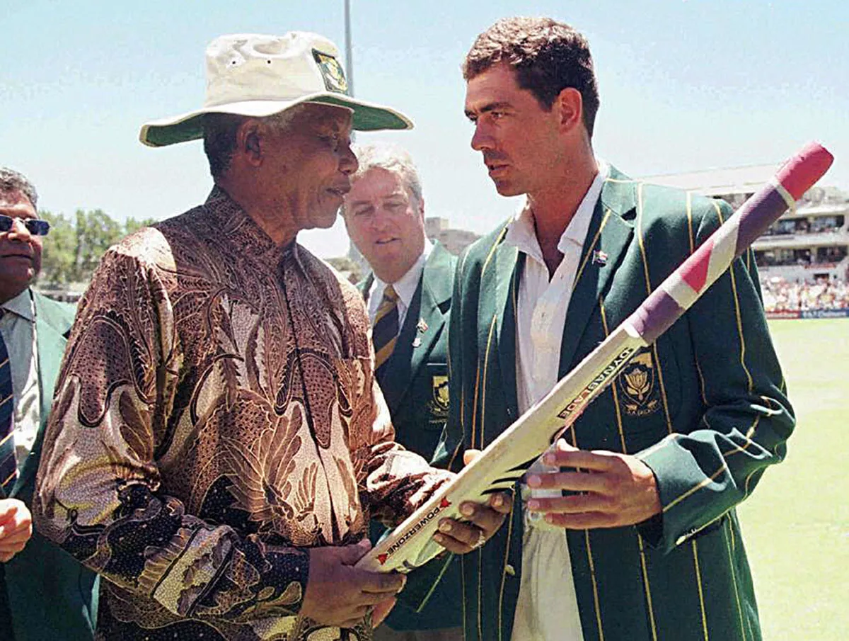 south african president nelson mandela receives a cricket bat from the south african cricket captain hansie cronje during the lunch break on the third day of the second test between south africa and india at newlands on january 4 1997 photo afp south african president nelson mandela receives a cricket bat from the south african cricket captain hansie cronje during the lunch break on the third day of the second test between south africa and india at newlands on january 4 1997 photo afp