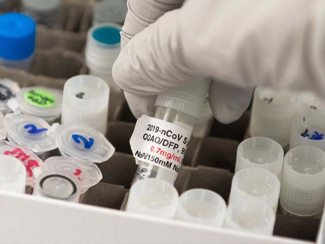 dr nita patel director of antibody discovery and vaccine development lifts a vial with a potential coronavirus vaccine photo getty