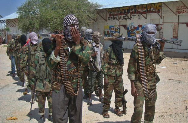 al qaeda linked al shabab recruits walk down a street on march 5 2012 in the deniile district of somali capital following their graduation photo afp