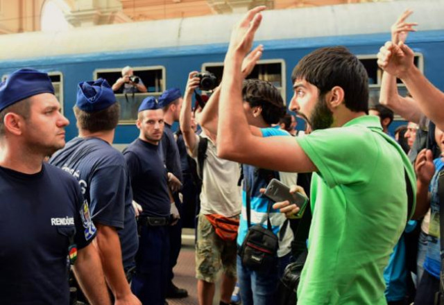 migrants protest at keleti railway station in budapest on september 1 2015 during its evacuation by local police photo afp migrants protest at keleti railway station in budapest on september 1 2015 during its evacuation by local police photo afp