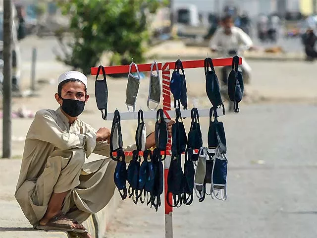 a vendor waits for customers as he sells face masks along a street photo getty a vendor waits for customers as he sells face masks along a street photo getty