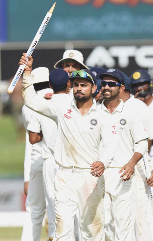 kohli walks off with a stump after claiming a historic win in his first full series since being appointed test captain photo afp kohli walks off with a stump after claiming a historic win in his first full series since being appointed test captain photo afp