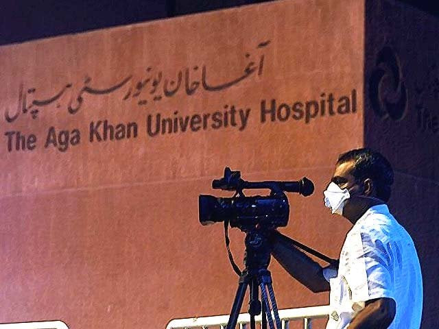 a cameraman wears a protective face masks as he films outside the aga khan university hospital photo getty
