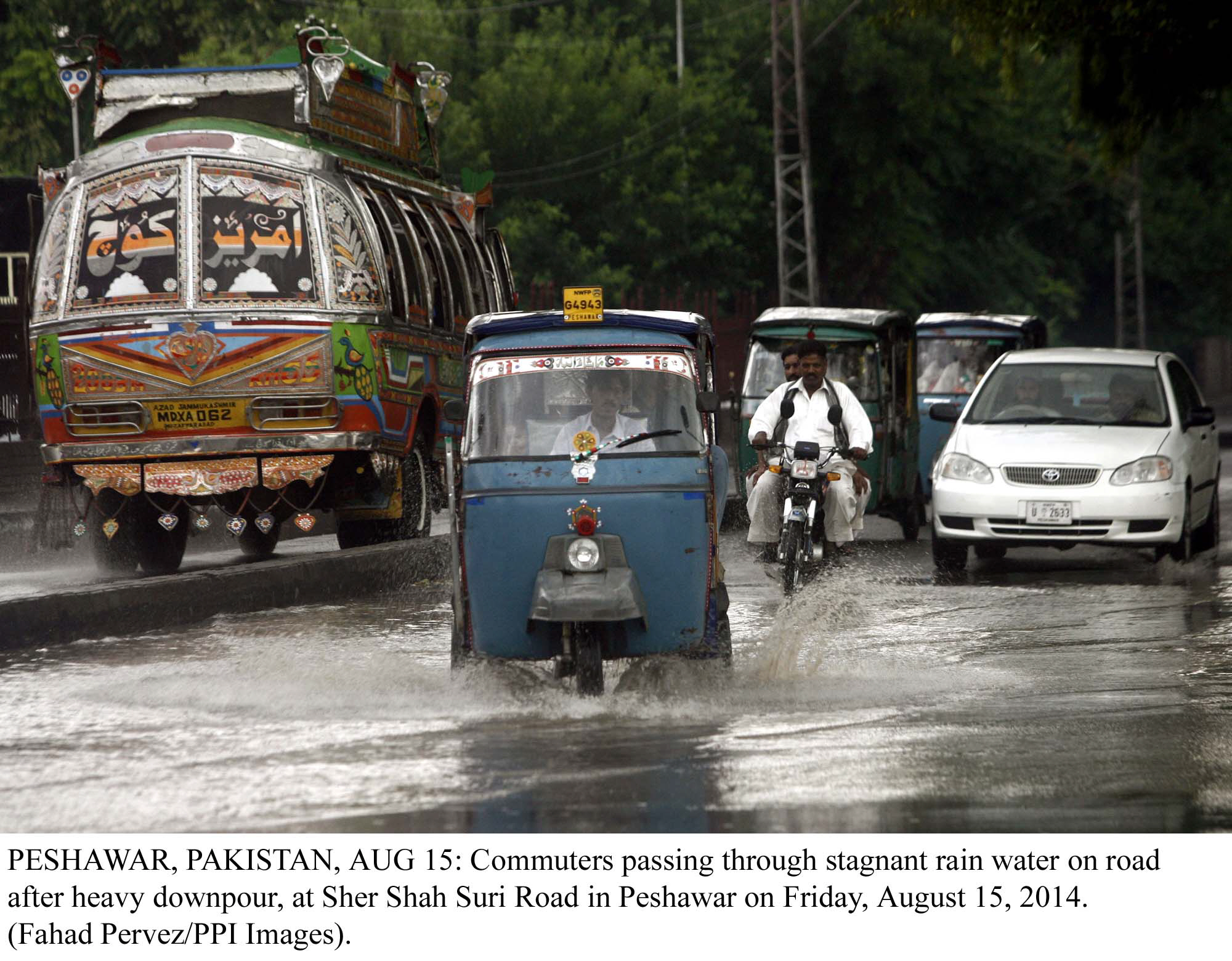 a rickshaw tries to navigate a flooded street in peshawar after heavy downpour photo ppi