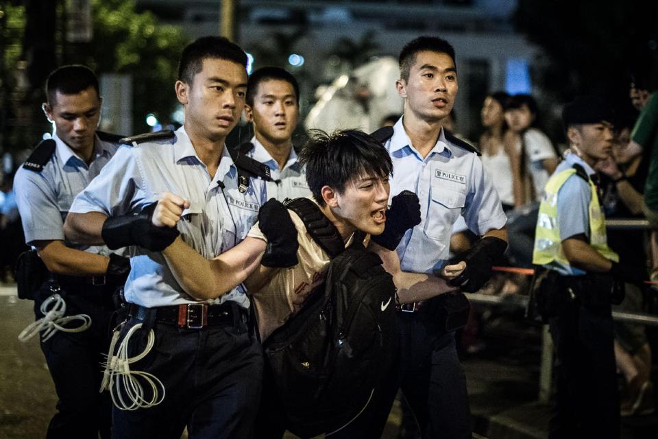 policemen remove protesters in the central district after a pro democracy rally seeking greater democracy in hong kong early on 2 july 2014 photo afp