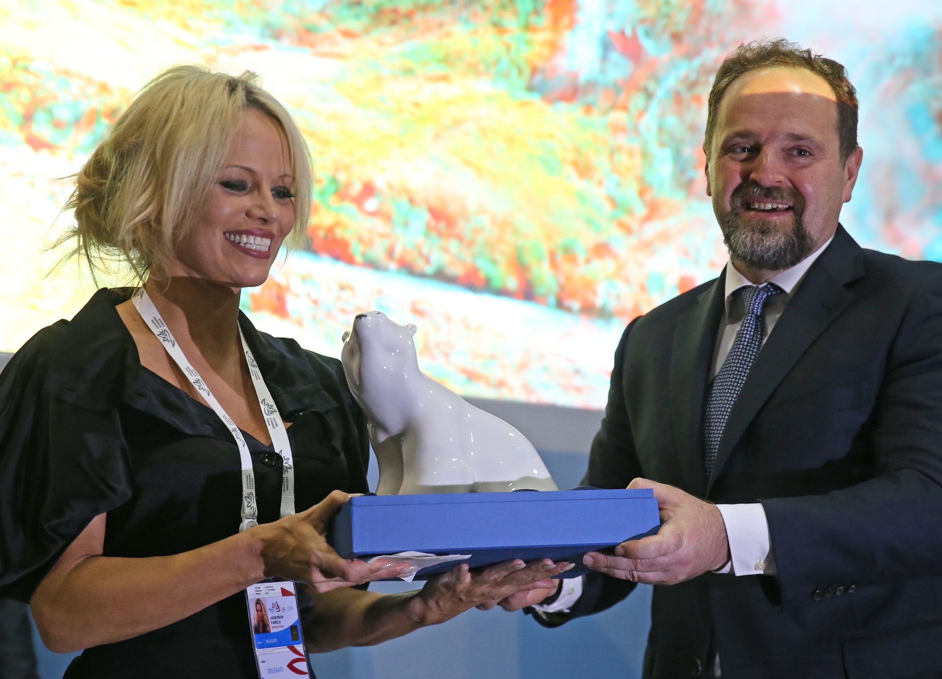 us canadian actress and animal rights activist pamela anderson l is presented with a polar bear statuette as she visits russia s first ever eastern economic forum eef in vladivostok on september 3 2015 photo afp