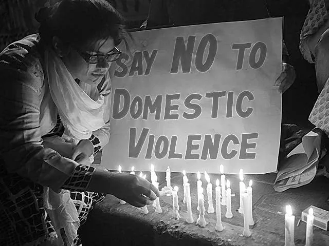 a woman lights a candle at a protest against domestic violence photo reuters a woman lights a candle at a protest against domestic violence photo reuters