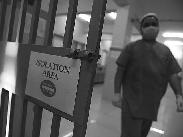a medical staff member walks in an isolation ward at the jinnah post graduate medical center jpmc photo getty a medical staff member walks in an isolation ward at the jinnah post graduate medical center jpmc photo getty