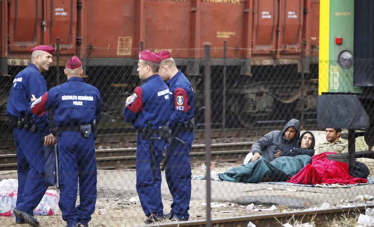 hungarian police officers stand next to migrants at the bicske railway station in bicske hungary september 4 2015 photo reuters