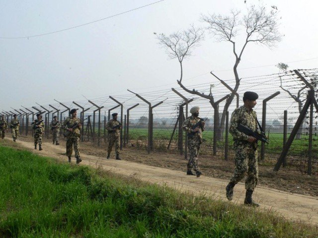 indian border security force soldiers patrol along the india pakistan border fence about 27 km from wagah photo afp
