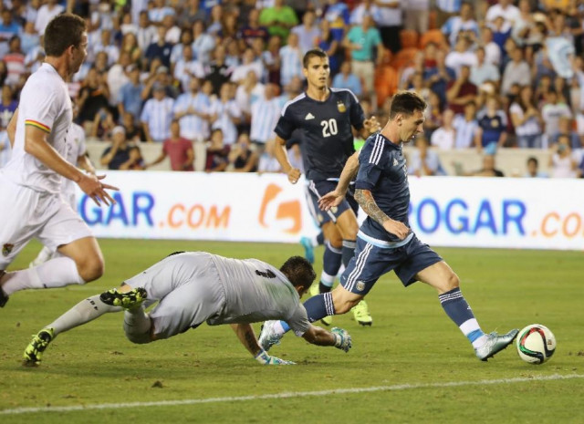 lionel messi of argentina scores a goal past dainel vaca of bolivia during their international friendly match at bbva compass stadium on september 4 2015 in houston texas photo afp lionel messi of argentina scores a goal past dainel vaca of bolivia during their international friendly match at bbva compass stadium on september 4 2015 in houston texas photo afp