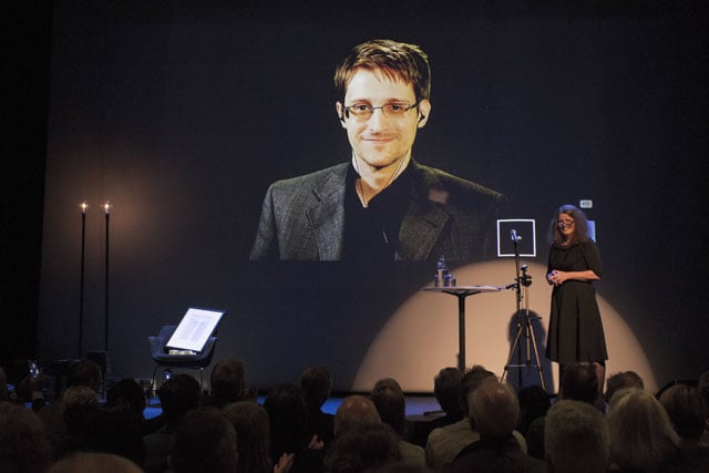 a giant screen displays the image of fugitive us intelligence contractor edward snowden as he is represented by an empty chair while being awarded the freedom of expression prize bjornson in molde norway on september 5 2015 photo afp