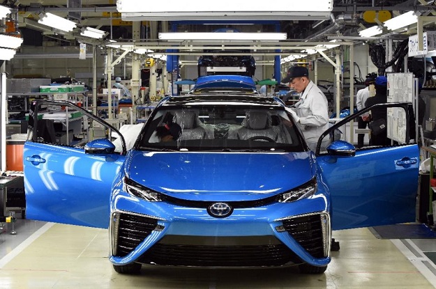 employees of toyota motors check the fcv quot mirai quot on its final assembly line during the vehicle 039 s line off ceremony at the motomachi factory in toyota city aichi prefecture on february 24 2015 photo afp