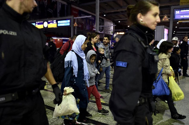 syrian refugees and migrants are detained by german police after arriving from austria at munich 039 s train station late september 3 2015 photo afp