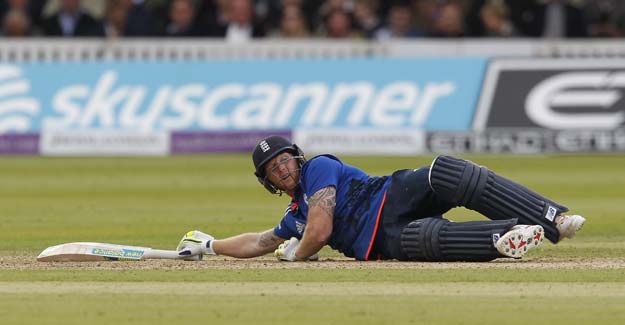 england s ben stokes reacts as he lays on the grass after hitting a ball away with his hand thrown by australia 039 s mitchell starc an consequently losing his wicket for quot obstructing the field quot during the second one day international odi cricket match between england and australia at lord 039 s cricket ground in london on september 5 2015 photo afp