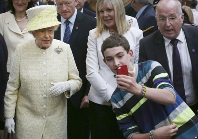a local youth takes a selfie photograph in front of queen elizabeth ii during a visit to st george 039 s indoor market on in belfast tuesday june 24 2014 photo ap a local youth takes a selfie photograph in front of queen elizabeth ii during a visit to st george 039 s indoor market on in belfast tuesday june 24 2014 photo ap