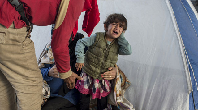 a child from syria cries at a gas station while waiting to be transported to a reception camp near the village of roszke hungary september 6 2015 photo reuters