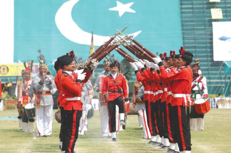 pakistan army officials display a mock combat exercise l pakistan rangers officials participate in a march past photo shafiq malik