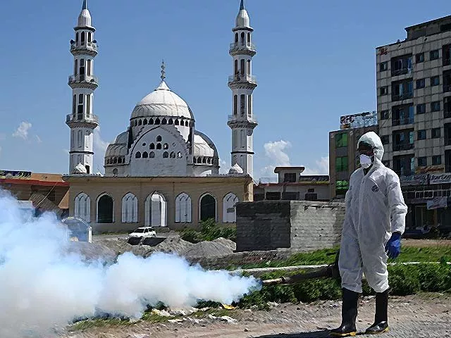 a worker wearing protective gear sprays disinfectant in islamabad photo getty a worker wearing protective gear sprays disinfectant in islamabad photo getty